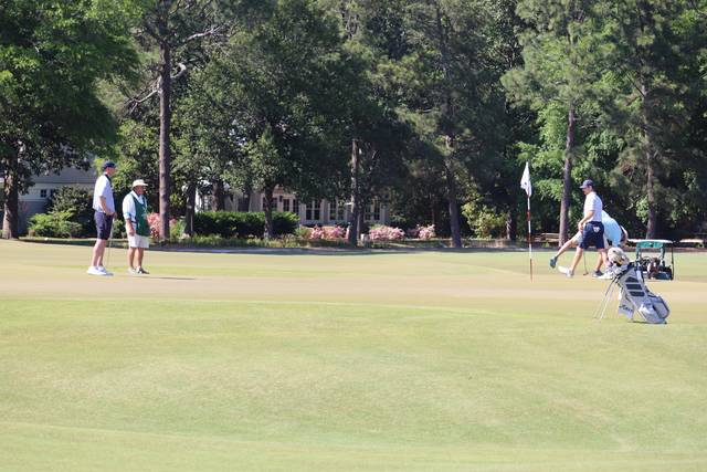 A group of golfers wrap up their round on the green at Pinehurst No. 2.
Neel Madhavan | Daily Journal