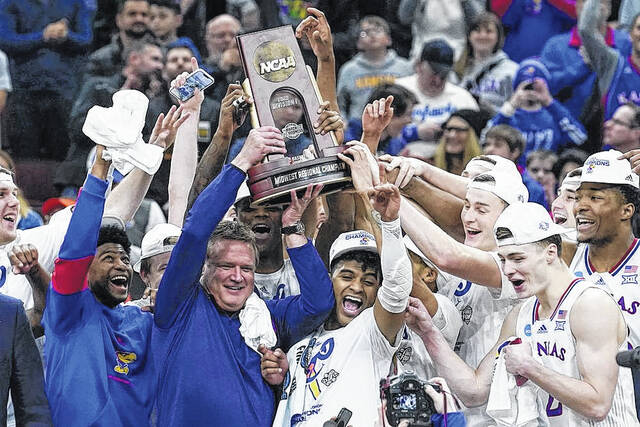 AP Photo | Charles Rex Arbogast
                                Kansas head coach Bill Self and players hold up the winning trophy after a college basketball game in the Elite 8 round of the NCAA tournament against Miami, March 27, 2022, in Chicago. This years Final Four is either unprecedented or pretty close. Kansas arrives having recently taken over the Division I lead in all-time wins.