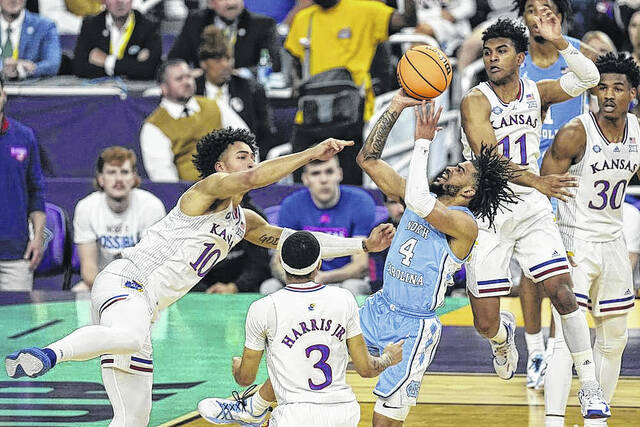 128378924_web1_APuncloss
AP Photo | Gerald Herbert
North Carolina guard R.J. Davis (4) shoots against Kansas forward Jalen Wilson (10) during the first half of a college basketball game in the finals of the Mens Final Four NCAA tournament, Monday, April 4, 2022, in New Orleans.
