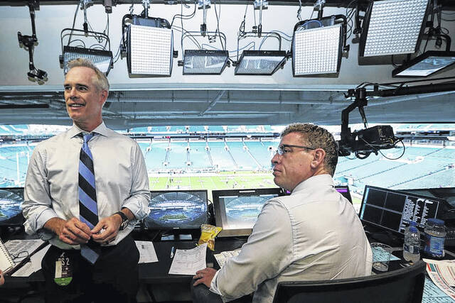 Fox Sports play-by-play announcer Joe Buck, left, and analyst Troy Aikman work in the broadcast booth before a preseason NFL football game between the Miami Dolphins and Jacksonville Jaguars in Miami Gardens, Fla., Aug. 22, 2019. On Monday, May 16, 2022, Buck and Aikman made their first trips to ESPN headquarters in Bristol, Connecticut, to meet with executives and their future co-workers as preparations for the upcoming season began to ramp up.
                                 AP Photo/Lynn Sladky