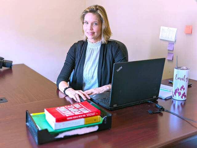 Emily Lamonds-Canter, a 2022 graduate of Richmond Community Colleges Office Administration program, sits at her desk at TDA Consulting Inc. in Laurinburg.
                                 Photo| Richmond Community College