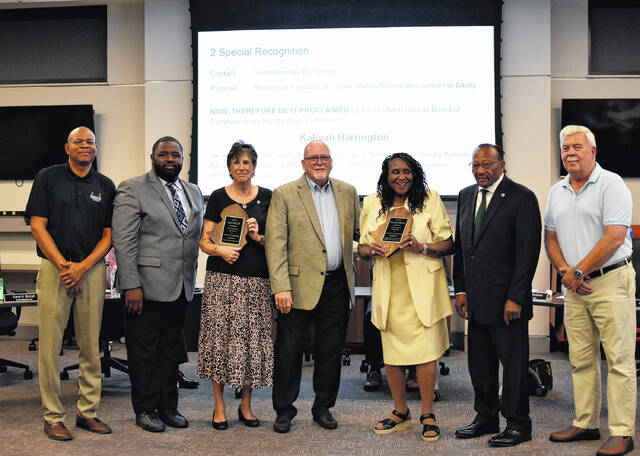 County Commissioners present Carol McCall (Third from left) and Betty Gholdson (third from right) with plaques for their service as county commissioners.
                                 Photo courtesy of Adam Peele