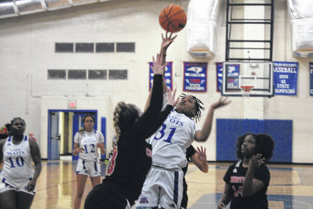 Lady Scots guard Morgan Thompson (31) rises for a floater over a Currituck County player during Thursday nights second round playoff matchup.
                                 Photos| Brandon Hodge/ The Laurinburg Exchange