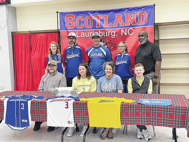 Scotland softballs Sydnee Dial (front center) signed her national letter of intent to continue her softball career at Columbia International University Friday morning, during a ceremony at Scotland High School, surrounded by her family and Scotland coaches and administrators.
Photo| Brandon Hodge/ The Laurinburg Exchange