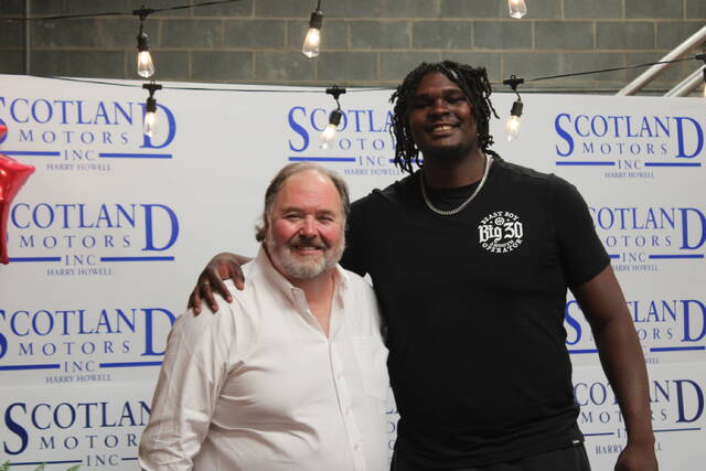 The president of Scotland Motors, Lee Howell (left), and NC State basketball player D.J. Burns Jr. (right) take a picture together before Tuesdays meet and greet event.
                                 Brandon Hodge | The Laurinburg Exchange