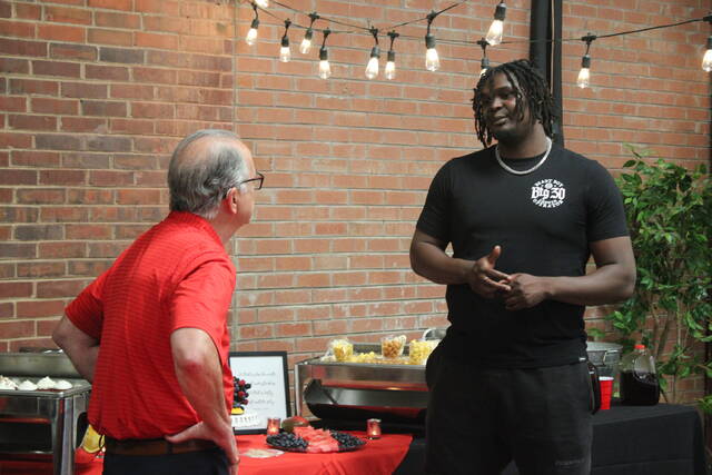 NC State basketball player D.J. Burns Jr. (right) talks to a meet and greet attendee (left) during Tuesdays meet and greet event.
                                 Brandon Hodge | The Laurinburg Exchange
