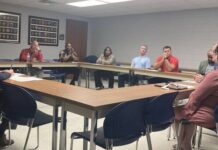 
			
				                                Attorney General Josh Stein listens as Richmond County Director of Social Services, Robbie Hall, describes the devastating effects of the opioid epidemic on the county. Hall said, “small communities solve problems,” illustrating the tremendous efforts of local officials and service providers.
 
			
		
