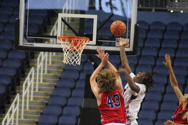 129826300_web1_IMG_2282
Lamonte Cousar (white jersey) puts up a layup over the Wests Patrick Tivnan (43) during Mondays East-West All-Star Mens Basketball Game at the Greensboro Coliseum.
Brandon Hodge | The Laurinburg Exchange