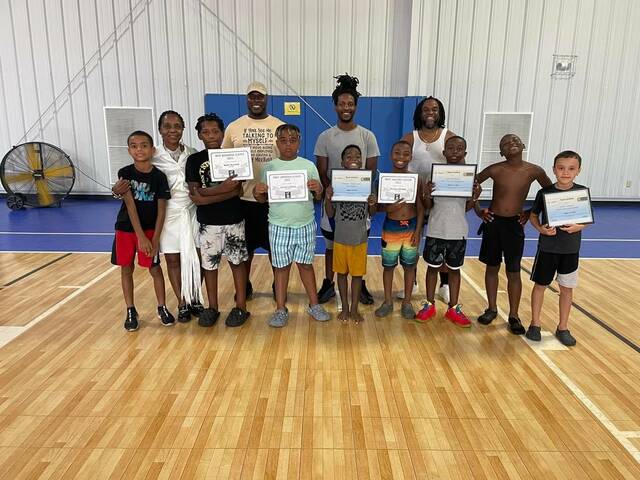 Players and award winners from the Team Unified third grade team take a picture with affiliates of the organization during the organizations end-of-the-year awards ceremony and cookout at the Wagram Recreation Center on Sunday.
                                 Contributed by Justin McNickle