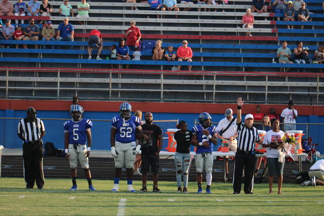 Scotland captains Malcom McGirt (5), Darreus McDougald (52), and Zay Jones (2) get ready to walk to center field with referees and the family of Zyshawn McInnis, a Scotland JV football player who tragically passed away earlier this year, before Friday nights season opener against Southern Durham at Pate Stadium.
                                 Brandon Hodge | The Laurinburg Exchange