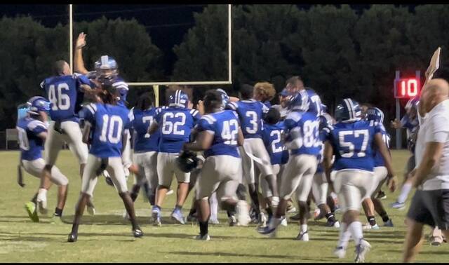 Scotland players and coaches celebrate on the field following Cameron Coles 37-yard eventual game-winning field goal during Friday nights season opener against Southern Durham at Pate Stadium.
                                 Brandon Hodge | The Laurinburg Exchange