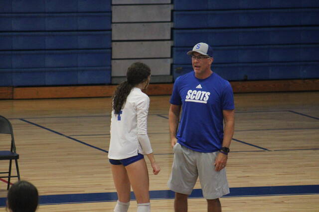 Scotlands Addison Johnson, left, and head coach Adam Romaine, right, have a discussion during Thursdays match against Hoke County.
                                 Brandon Hodge | The Laurinburg Exchange
