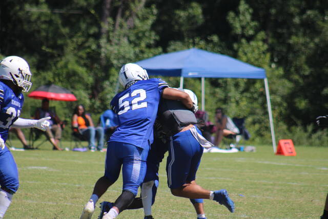 St. Andrews Nick Henderson (52) and another Knights player tackle Lindsey Wilsons Logan Collier (gray jersey) during a Sep. 2 game in Laurinburg.
File photo