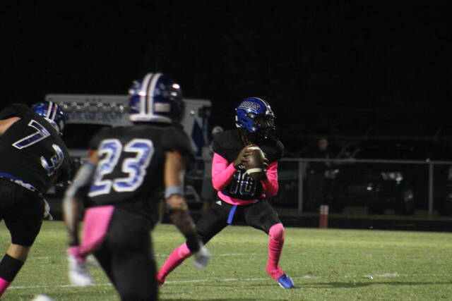 Scotlands JiSan McPhatter (10) drops back to pass during Friday nights game against Pinecrest at Pate Stadium in Laurinburg.
                                 Brandon Hodge | The Laurinburg Exchange