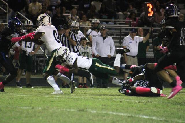 Multiple Scotland players tackle Pinecrests Zymire Spencer (23) during Friday nights game at Pate Stadium in Laurinburg.
                                 Brandon Hodge | The Laurinburg Exchange