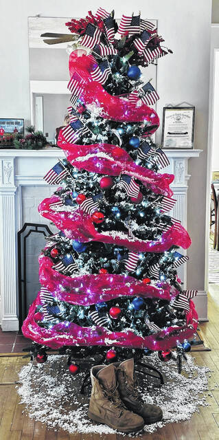 130251744_web1_Tree
Local business Weichert Realtors Associated Group / McMillan Rentals is recognizing soldiers who have passed by displaying their Fallen Soldiers 2023 Christmas Tree. The tree features American Flags throughout while being surrounded by snow and a pair of military boots.
Courtesy photo