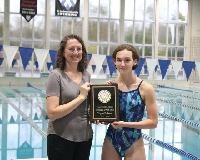 <p>Scotland swimming coach Aliechia Post, left, and Taylor Johnson, right, pose for a picture after Johnson received the 2022-23 Sandhills Athletic Conference Women’s Swimmer of the Year award during a Jan. 15 practice.</p>
<p>File photo</p>