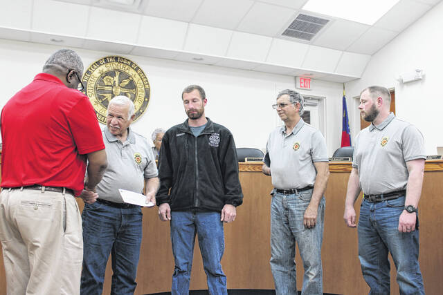130511813_web1_IMG_2006
Wagram Town Clerk Roosevelt Henegan presents a check for $20,000 to North Scotland Volunteer Fire Departments assistant chief David Clark Thursday during the meeting of the towns board of commissioners.