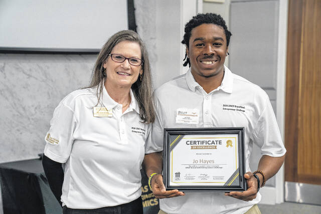 Jo Hayes, right, earned first place in the BraveHawk Entrepreneur Challenge at The Univerisity of North Carolina at Pembroke. Hayes is shown with UNCP Provost Diane Prusank
                                 Courtesy photos | UNCP