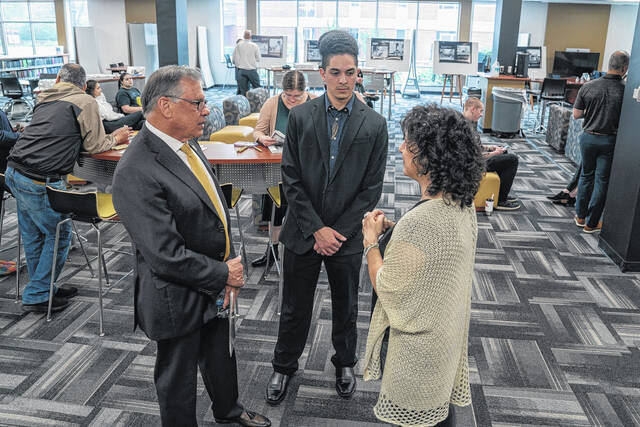 130538559_web1_UNCP_REACH---Ahelayus-Oxouzidis-_DSC1547-2024_04_03--m
Ahelayus Oxouzidis, center, engages with Chancellor Robin Gary Cummings, left, and Dr. Michele Fazio during an exhibition at the Mary Livermore Library. The exhibit features several digitally enlarged photos and a dozen other digitally enhanced placed in albums.
UNCP
