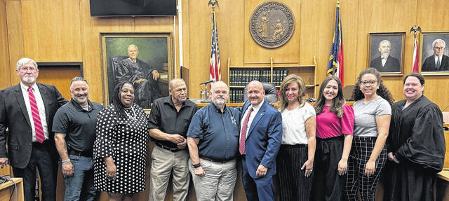130803322_web1_Magistrate-Swearing-in
Shown are Scotland County Clerk of Court Philip McRae, magistrates Sal Marcano and Sandra Miller, retired magistrate Donnie Chavis, chief magistrate Mike Nobles, newly installed magistrate Vernon Jackson with his wife and children, and district court judge Chavonne Wallace.