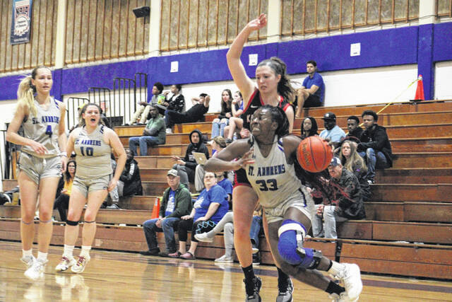 131013796_web1_CMYK-1--3-
The St. Andrews Knights womens basketball team enters the 2024-25 season with a new head coach and sense of energy. Here, Ashley Starks (33) drives along the baseline while being defended by a Kentucky Christian player during a game last season at Harris Court in Laurinburg. They will start their season in Spartanburg, South Carolina on Monday.
File Photo