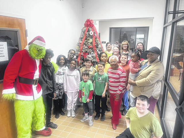 131156168_web1_The-Grinch
About 20 students from Wagram Elementary School and Spring Hill Middle School stopped by Wagrams Town Hall to help spruce up the towns Christmas tree with ornaments on Tuesday. While decorating, students were surprised by a visit from the Grinch, who presented the youth with some Christmas funds. The Town also gave each child a Christmas gift bag.
Courtesy photo | Town of Wagram