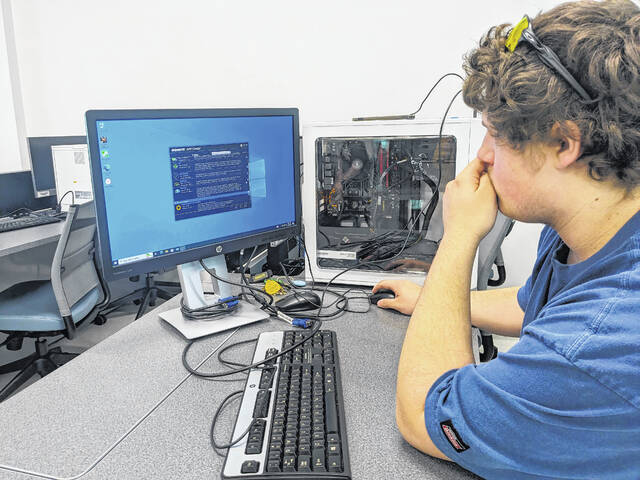 131362433_web1_IT_cybersecurity
A student in Richmond Community Colleges cybersecurity program works on a lesson involving computer hardware.