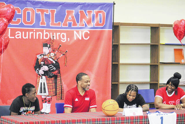 131489781_web1_IMG_5113
Scotland senior Morgan Thompson signs her papers to play collegiate basketball at Newberry College on Monday afternoon during a signing ceremony at the Scotland High School media center.
Andrew Smolar | The Laurinburg Exchange
