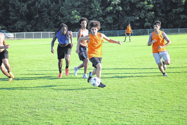 131674796_web1_IMG_8915--1-
Nathan Ward pushes the ball forward as teammates trail during Scotlands opening soccer practice.
Travis Petty Jr | The Laurinburg Exchange