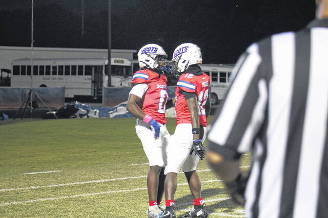 <p>Senior Tyjurian White (0) is congratulated by junior Samier Pate after scoring a touchdown against Terry Sanford on Oct. 10, 2025. </p>
<p>Travis Petty Jr | The Laurinburg Exchange</p>