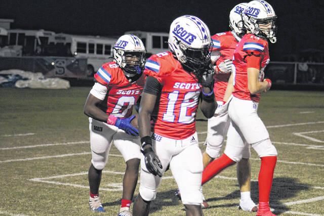 <p>Senior Tyjurian White (0) celebrates after scoring a touchdown for the Scots during their game against Terry Sanford on Oct. 10, 2025. He’s joined by junior Samier Pate (12) and teammates as they head back to the sideline.</p>
<p>Travis Petty Jr | The Laurinburg Exchange</p>