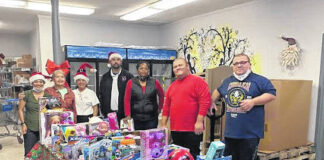 
			
				                                Volunteers and supporters of the Christmas Cheer program show off toys and donations that will help brighten the holidays for children across Scotland County.
 
			
		