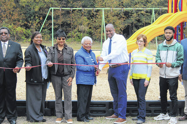 <p>Flanked by public officials, Mayor Barbaran Pierce and Scotland County Parks and Recreation Director Lawrence Baker cut the ribbon Friday on new playground equipment at Charles F. Murray Park in Wagram.</p>
<p>Tomeka Sinclair | The Laurinburg Exchange</p>