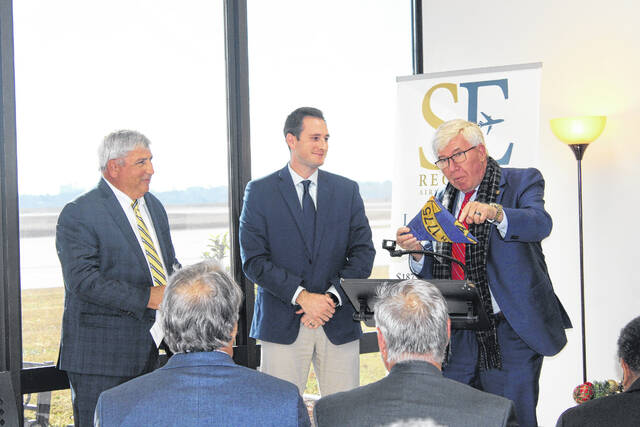 <p>Sen. Tom McInnis presents to Laurinburg-Maxton Airport officials during a ribbon cutting for a new terminal.</p>
<p>Tomeka Sinclair | The Laurinburg Exchange</p>