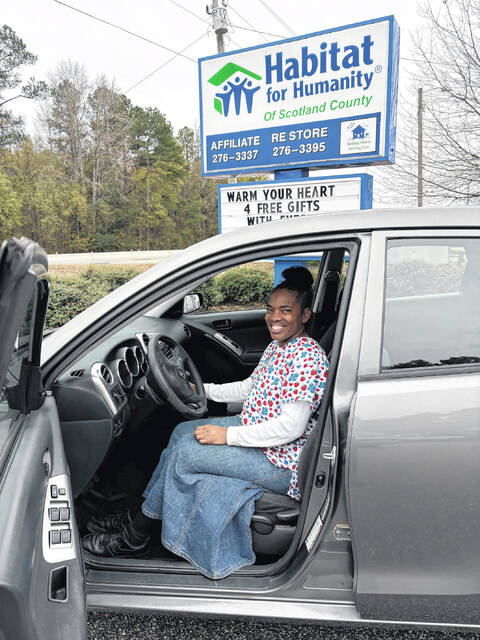 <p>Terry Easterling of Laurinburg is all smiles beside the car she won in a Habitat for Humanity of Scotland County raffle. Easterling said she had been struggling with unreliable transportation before winning the vehicle.</p>
<p>Courtesy photo | Habitat for Humanity of Scotland County</p>