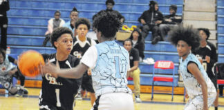 
			
				                                GB Baller player handles the ball while being closely guarded by an Oiler defender during the annual alumni basketball game on Dec. 20 at Scotland High School.
                                 Travis Petty Jr | The Laurinburg Exchange

			
		