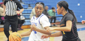 
			
				                                Lady Scot (4) looks to drives past a Lumberton defender on Jan. 23, 2026.
                                 Travis Petty Jr | The Laurinburg Exchange

			
		