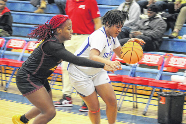 <p>Scots junior Shaniya David-Voland (1) attempts to drive around a Lumberton defender on Jan. 23, 2026. </p>
<p>Travis Petty Jr | The Laurinburg Exchange</p>