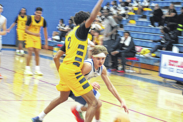 <p>Scots sophomore Maddon McNickle (12) drives through contact from a Cape Fear defender on Jan. 27, 2026. </p>
<p>Travis Petty Jr | The Laurinburg Exchange</p>