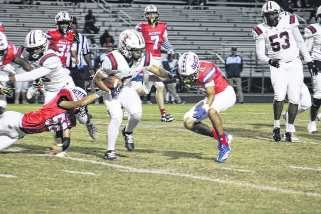 Terry Sanford ball carrier attempts to break free as Scotland senior defensive back Shylan Harrell(11) makes a tackle at Pate Stadium on Oct.10,2025.
                                 Travis Petty Jr | The Laurinburg Exchange