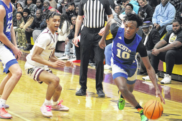 Scots sophomore Nazire Campbell (10) drives past a Lumberton defender on Feb. 10, 2026. 
                                 Travis Petty Jr | The Laurinburg Exchange
