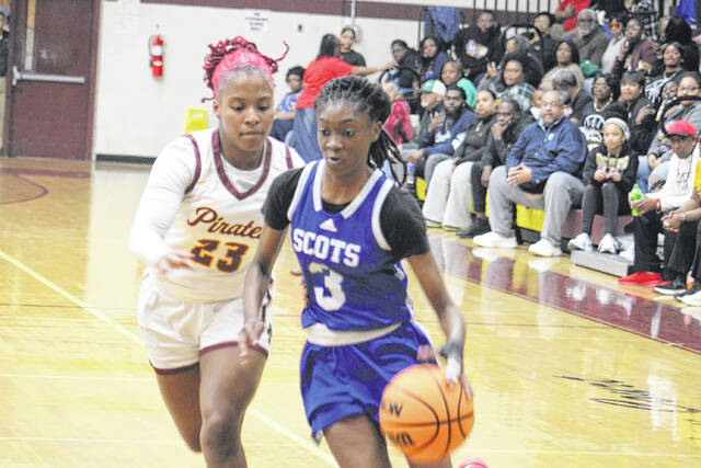 Scots freshman Amaria Bostick (3) drives past a Lumberton defender on Feb. 10, 2026. 
                                 Travis Petty Jr | The Laurinburg Exchange