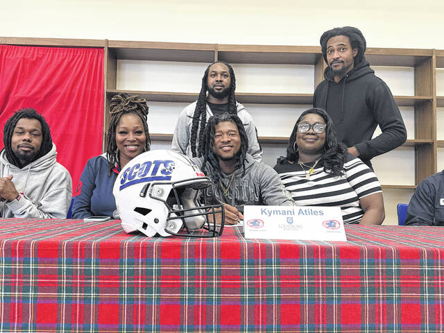 Kymani Atiles, center, poses for a photo surrounded by family on March 13, 2026.
                                 Travis Petty Jr | The Laurinburg Exchange