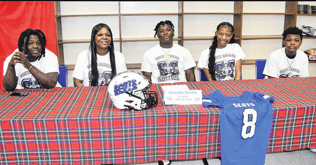 Deondre Braddy, center, poses with family after signing his letter of intent to attend South Carolina Central Christian College. 
                                 Courtesy Photo