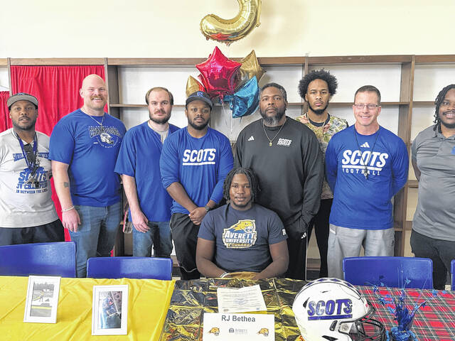 RJ Bethea, center, is joined by Scotland football coaches for a photo on March 27, 2026.
                                 Travis Petty Jr | The Laurinburg Exchange