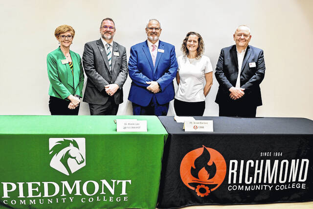 Shown are Alisa Montgomery, left, Dean of Health and Public Services for Piedmont Community College; Kevin Lee, PCC president; Richmond Community College President Brent Barbee; RichmondCC 911 Communications and Operations Program Coordinator Jamison Sears; RichmondCC Executive Vice President and Chief Academic Officer Kevin Parsons.
                                 Courtesy photo
