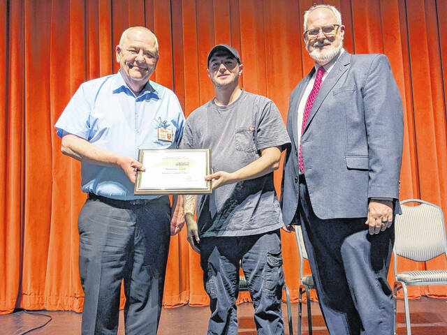 Richmond Community College HVAC student Braxton Lett accepts the Academic Excellence Award from Executive Vice President and Chief Academic Officer Kevin Parsons and President Brent Barbee.
                                 Courtesy photo | RichomondCC
