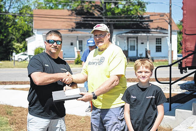 Mike Williams of Just PorkN Que poses with his first-place award in the backyard division at the Suds and Swine festival in Laurinburg.
                                 Katelin Gandee | The Laurinburg Exchange