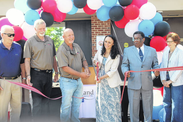 Amanda Holland, director of the Health and Human Services agency, cuts the ribbon Friday during a ceremony marking the consolidation of the countys health and social services departments in Scotland County.
                                 Tomeka Sinclair | The Laurinburg Exchange